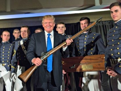 CHARLESTON, SC - FEBRUARY 22: Reality TV host and New York real estate mogul Donald Trump holds up a replica flintlock rifle awarded him by cadets during the Republican Society Patriot Dinner at the Citadel Military College on February 22, 2015 in Charleston, South Carolina. Trump and U.S. Sen. Tim …