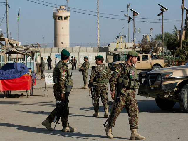 Afghanistan's National Army soldiers guard, blocking the main road to the Bagram Airfield'