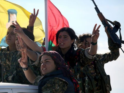 SINJAR, IRAQ - NOVEMBER 15: Yazidi soldiers cheer a fallen comrade on November 15, 2015 ne