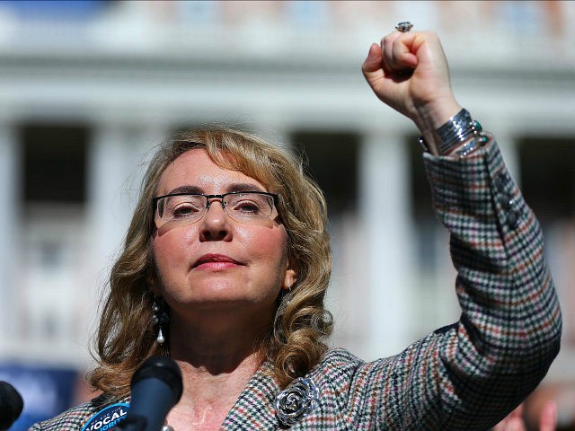 BOSTON - OCTOBER 14: Congresswoman Gabrielle Giffords raises he fist as she addresses a crowd during a rally for gun reforms on Boston Common on Oct. 14, 2016. (Photo by John Tlumacki/The Boston Globe via Getty Images)
