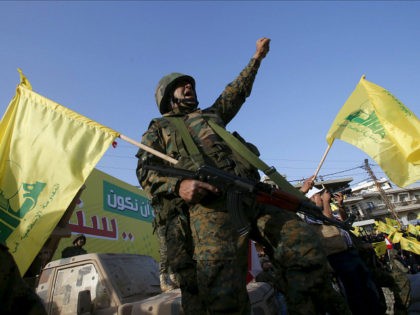 A Hezbollah member reacts while Hezbollah leader Sayyed Hassan Nasrallah talks on a screen