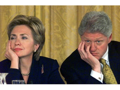 WASHINGTON, : US First Lady Hillary Clinton and US President Bill Clinton listen to testimonials from a wide range of individuals about half way through the four-hour 'White House Conference on Philanthropy: Gifts to the Future' 22 October 1999 in the East Room of the White House in Washington, DC. …