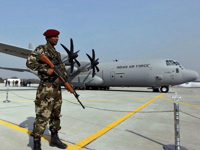 FILE- In this Feb. 5, 2011 file photo, a Special Forces commando stands guard near the C-130J-30 Super Hercules aircraft that it inducted into its transportation fleet, at a ceremony at the Air Force Station at Hindon near New Delhi, India. India is beefing up its defenses with new infantry …