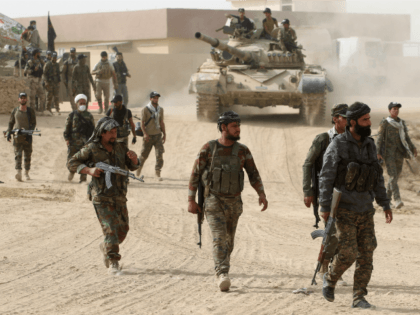 Shiite fighters from the Hashed al-Shaabi (Popular Mobilisation Units) enter the village o