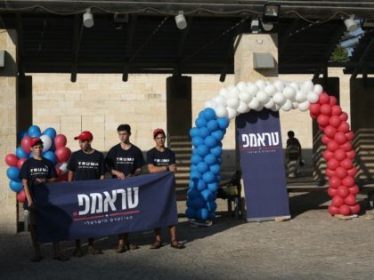 US Marc Zell (2nd L), the chairman of Republicans living in Israel, talks while youths hold a banner reading 'Trump' (Donald) in Hebrew as the Israeli branch of the US Republican party started its first ever election campaign in the central Israeli city of Modiin, on August 15, 2016. / …