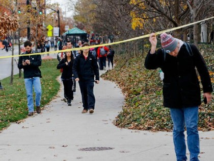 Ohio State students duck under police tape after a shelter-in-place notification was lifted following an attack Monday, Nov. 28, 2016, at Ohio State University in Columbus, Ohio. (Joshua A. Bickel/The Columbus Dispatch via AP)