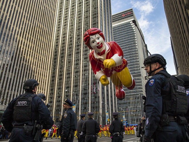 The Ronald McDonald balloon makes its way across Sixth Avenue as heavily armed police stand guard during the Macy's Thanksgiving Day Parade, Thursday, Nov. 26, 2015. (AP Photo/Andres Kudacki)