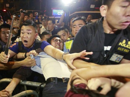 Protesters scuffle with police officers after clashing as thousands of people march in a Hong Kong street, Sunday, Nov. 6, 2016. Thousands of protesters marched in Hong Kong on Sunday, demanding that China's central government stay out of a political dispute in the southern Chinese city after Beijing indicated that …