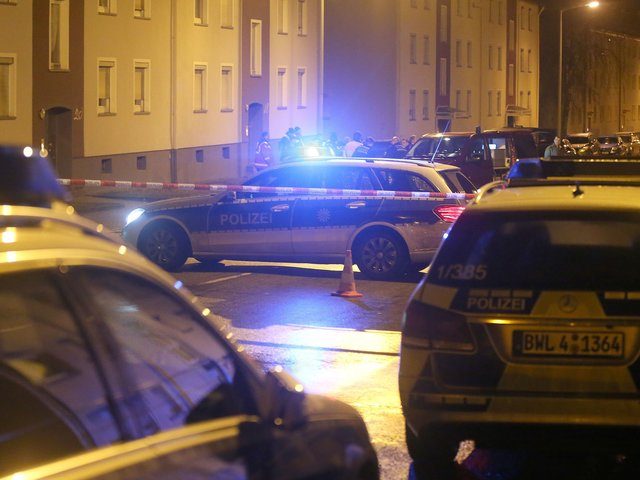 Emergency personell are seen outside a building housing asylum seekers in Villingen-Schwenningen, southern Germany on January 29, 2016. Unknown assailants hurled a hand grenade at a shelter for asylum seekers in southern Germany on Friday but the device did not explode and no one was injured, police said. The grenade …