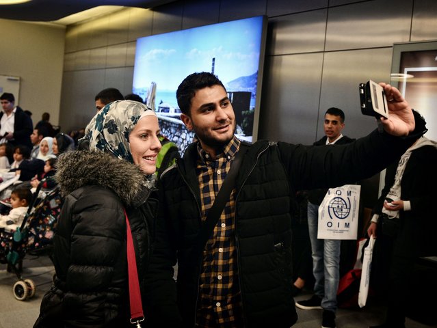Houda and her husband take a selfie at the airport in Athens before boarding a special cha