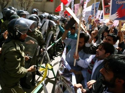 Foreign clerics living in Iran face security forces as they demonstrate in front of the Saudi Arabia embassy in Tehran on April 8, 2011, to support Bahrain protesters against the violent crackdown by the ruling Sunni dynasty in the capital Manama, two days after more than 200 Iranian parliamentarians condemned …
