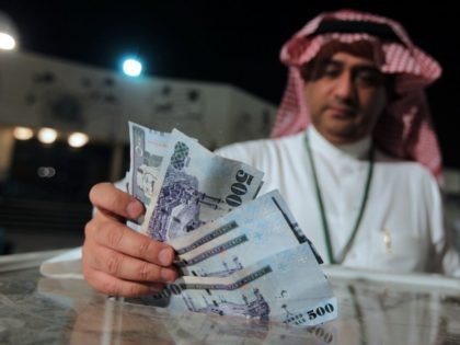 A Saudi man donates money for the Syrian people in Riyadh in the early hours of July 24, 2