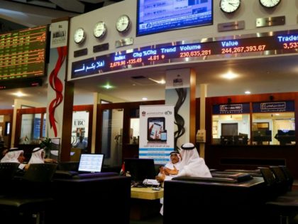 Traders sit at the Dubai bourse as prices of shares are reflected on screens in red above them on January 17, 2016 Share prices in the energy-rich Gulf states nosedived following the sharp decline in oil prices and the expected rise in Iranian crude exports after the sanctions imposed on …