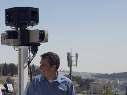 Meir Brand, the managing director of Google Israel, pose with a camera mounted on a tricycle overlooking Jerusalem's Old City during a press conference on September 12, 2011, after the justice ministry gave the go-ahead for Google Street View to start photographing streets in Israel to put on its 3D-mapping …