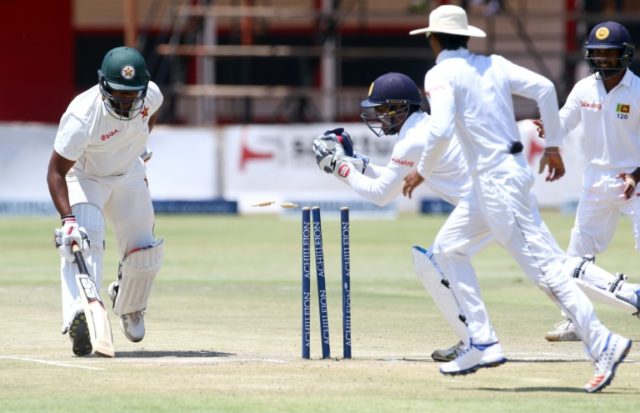 Zimbabwe's batsman Hamilton Masakadza (left) survives a run out attempt by wicketkeeper Ku