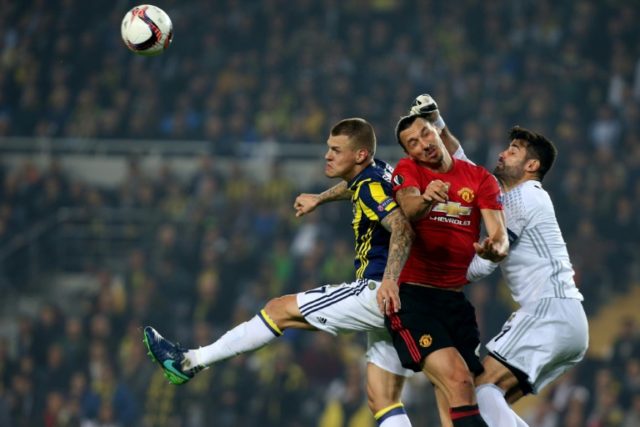 Manchester United's Zlatan Ibrahimovic (C) vies with Fenerbahce's Martin Skrtel (L) and