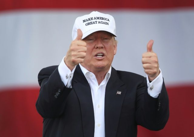 Republican presidential candidate Donald Trump flashes two thumbs up during a campaign ral