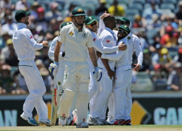 South Africa's bowler Vernon Philander (3rd R) is embraced by teammates after making a suc