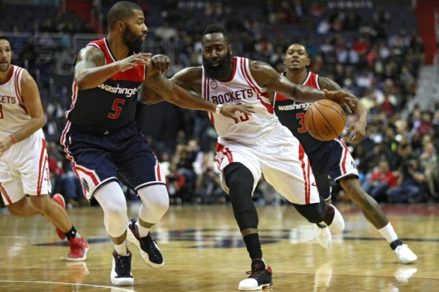 James Harden of the Houston Rockets dribbles the ball past Markieff Morris of the Washingt