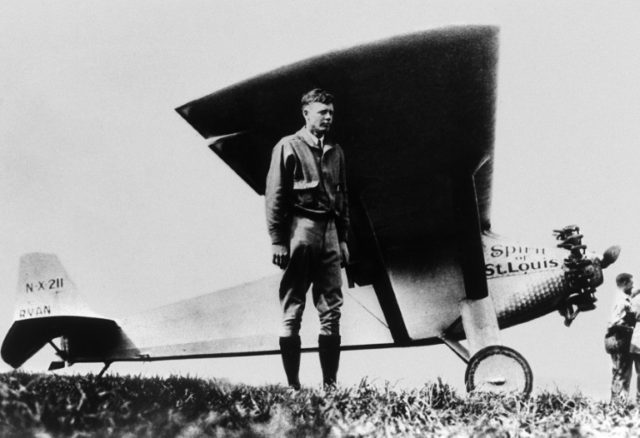 Charles Lindbergh stands next to his monoplane -- Spirit of St-Louis -- after landing at P