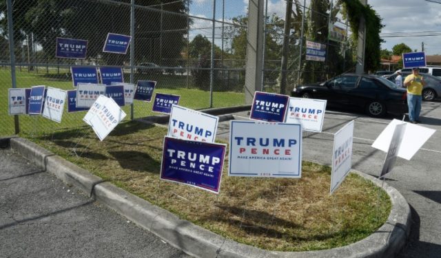 Donald Trump for president signs are placed in front of a polling center in Miami, Florida