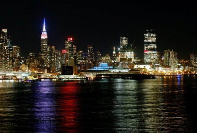 The Empire State Building in New york is lit in Red, White and Blue oolors before the clos