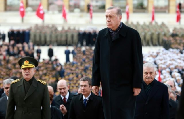 Turkish President Recep Tayyip Erdogan (C) visits Mustafa Kemal Ataturk's mausoleum during