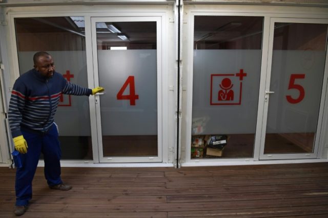 A worker checks medical facilities at a new refugee centre, ahead of its opening, in north