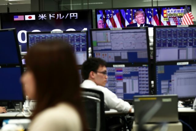 Japanese employees of a foreign exchange trading company work at their terminals in Tokyo