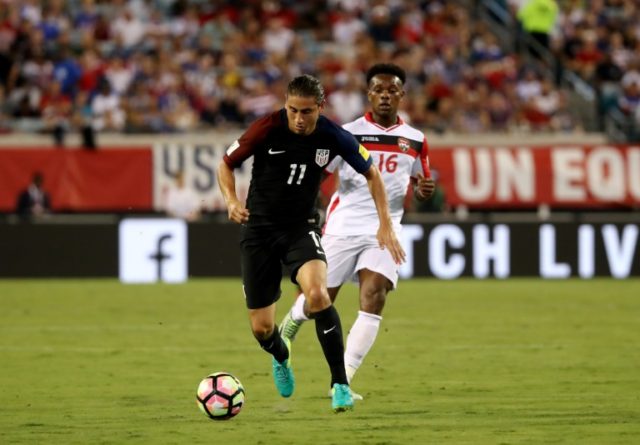 Alejandro Bedoya #11 of the United States drives past Levi Garcia #16 of Trinidad and Taba