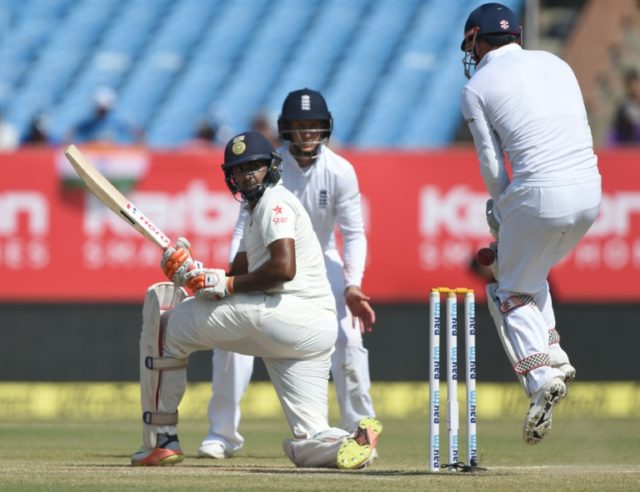India's Ravichandran Ashwin (L) watched by England's Joe Root (C) and wicketkeeper Jonny B