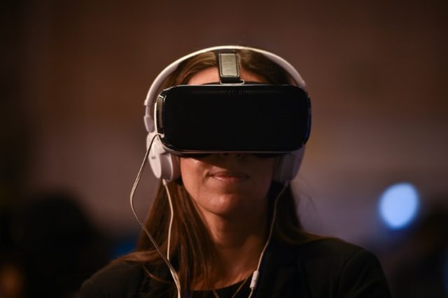 A Websummit attendee tries a virtual reality goggles during the Web Summit at Parque das N