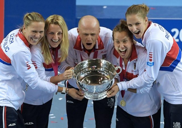 Czech Republic's players pose with the trophy after winning the Fed Cup final against Fran