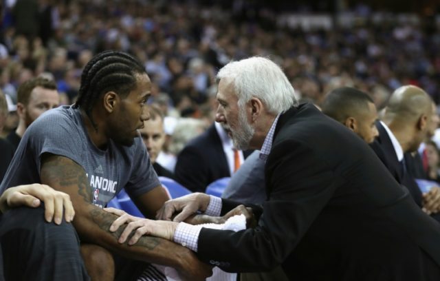 Head coach Gregg Popovich of the San Antonio Spurs talks to Kawhi Leonard during a NBA gam