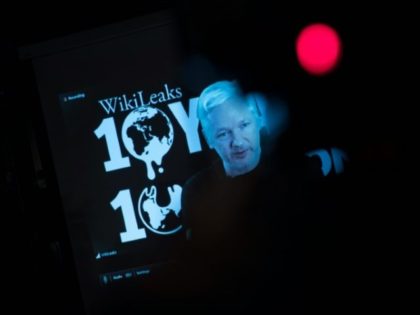 Julian Assange, founder of WikiLeaks, is seen on a screen as he addresses journalists via a live video connection during a press conference on October 4, 2016 in Berlin