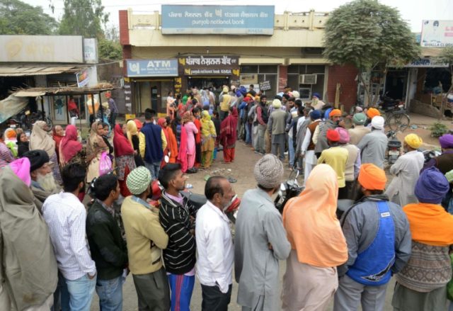 Villagers queue outside a bank in Khasa village, some 20kms from Amritsar, northwest India