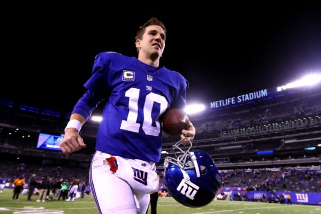 Eli Manning of the New York Giants walks off the field after defeating the Cincinnati Beng