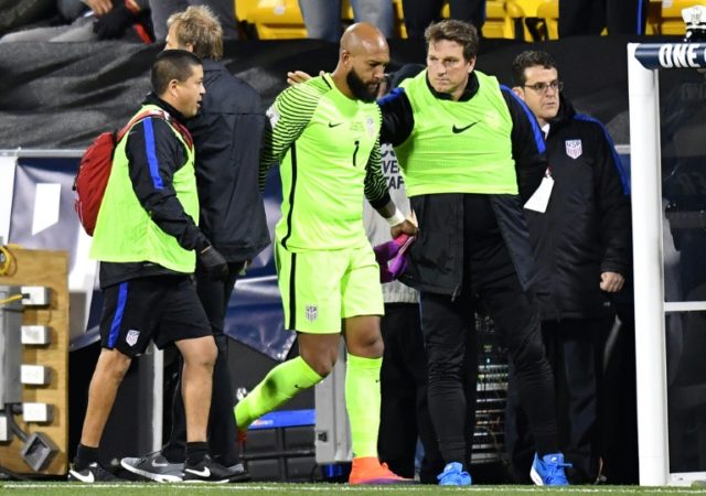 US goalkeeper Tim Howard is helped off of the field after being injured in the first half