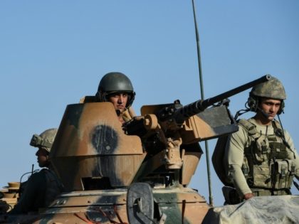 Turkish soldiers stand in a Turkish army tank driving back to Turkey from the Syrian-Turkish border town of Jarabulus on September 2, 2016 in the Turkish-Syrian border town of Karkamis