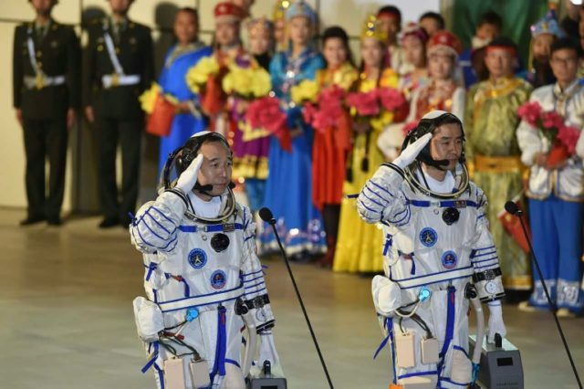 Chinese astronauts Jing Haipeng (L) and Chen Dong, pictured at their send-off ceremony, sp