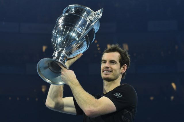 Britain's Andy Murray poses holding the ATP World Number One trophy after winning the men'