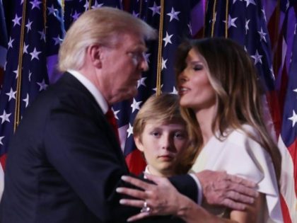 President-elect Donald Trump embraces his wife Melania Trump, as their son Barron looks on