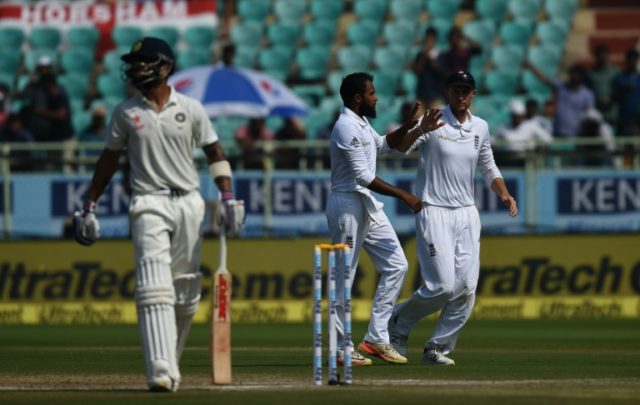England's Adil Rashid (C) celebrates the wicket of India's captain Virat Kohli with teamma