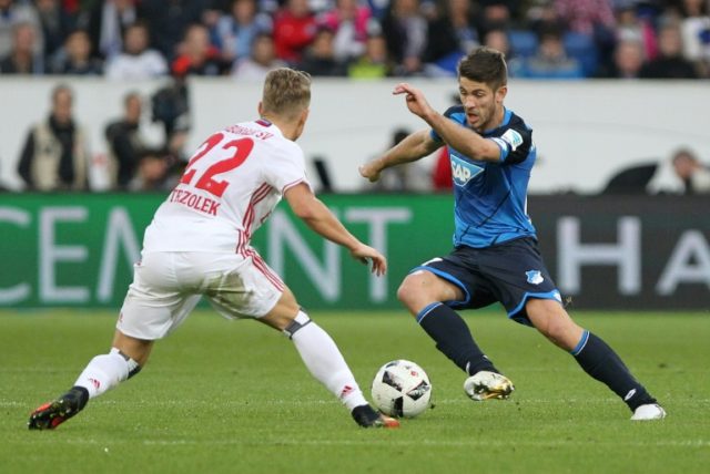 Hoffenheim's forward Sandro Wagner and Hamburg's defender Matthias Ostrzolek (L) vie for t
