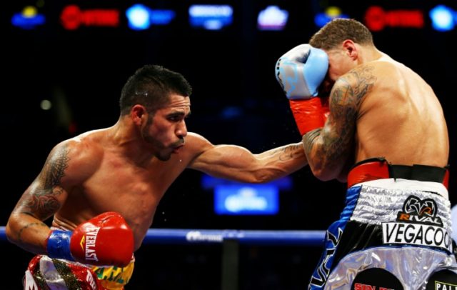 Jesus Cuellar (L) of Argentina punches Jonathan Oquendo of Puerto Rico during their WBA Fe