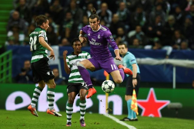 Sporting's defender Joao Pereira (L) jumps for the ball with Real Madrid's forward Gareth