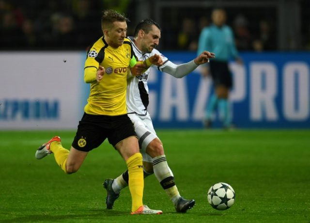 Marco Reus (left) is netted a hat-trick in Borussia Dortmund's record 8-4 hammering of Leg