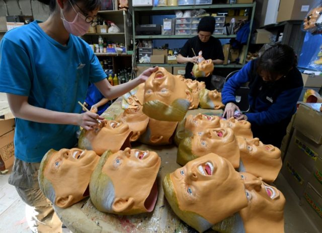 Employees produce rubber masks of US President-elect Donald Trump at the Ogawa Studios mas