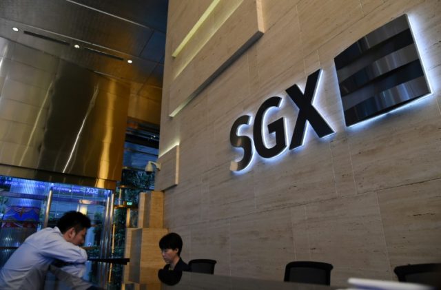 Three people whose alleged fraud wiped $5.6 bn off the Singapore stock exchange are charge