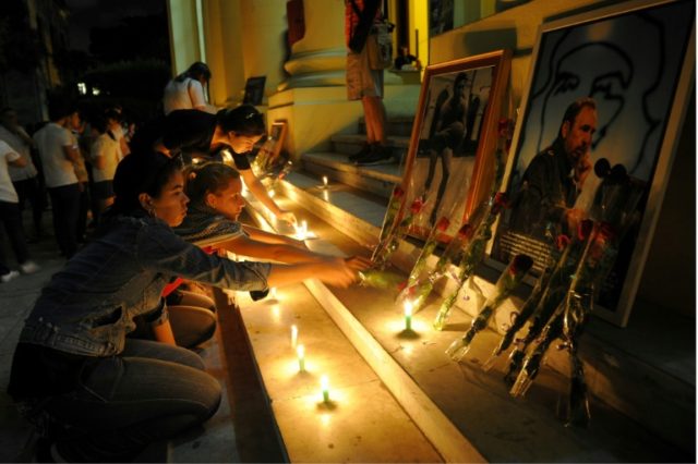 Students light candles in honour of Cuban revolutionary leader Fidel Castro at the Havana